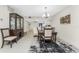 Charming dining room with dark wood table and view of kitchen at 9900 Fiddlers Green Cir # 137, Rotonda West, FL 33947