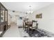 Bright dining area features a dark wood table and rug at 9900 Fiddlers Green Cir # 137, Rotonda West, FL 33947