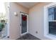 Condo entrance with a red wreath and welcome mat at 9900 Fiddlers Green Cir # 137, Rotonda West, FL 33947