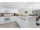 White kitchen with appliances and peninsula counter at 9900 Fiddlers Green Cir # 137, Rotonda West, FL 33947