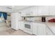 White kitchen with appliances and small desk area at 9900 Fiddlers Green Cir # 137, Rotonda West, FL 33947