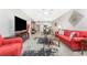 Spacious living room with red sofa and view of dining area at 9900 Fiddlers Green Cir # 137, Rotonda West, FL 33947