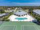 Community pool and tennis courts with clubhouse at 9900 Fiddlers Green Cir # 137, Rotonda West, FL 33947