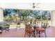 Screened porch with patio furniture and view of backyard at 9900 Fiddlers Green Cir # 137, Rotonda West, FL 33947