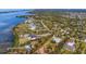 Aerial view of waterfront property with lush landscaping and multiple houses at 1080 Bayshore Dr, Englewood, FL 34223