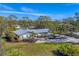 Drone view of single-story home with a spacious yard and tropical landscaping at 1080 Bayshore Dr, Englewood, FL 34223