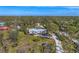 Aerial view showing a home nestled in a wooded area at 1080 Bayshore Dr, Englewood, FL 34223