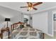 Bright bedroom featuring a ceiling fan and double door closet at 1080 Bayshore Dr, Englewood, FL 34223