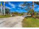 Gravel driveway leading to a single-story home at 1080 Bayshore Dr, Englewood, FL 34223