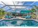 Inviting pool area with lounge chairs and covered patio at 1080 Bayshore Dr, Englewood, FL 34223