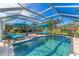 Inviting pool area with lounge chairs and covered patio at 1080 Bayshore Dr, Englewood, FL 34223