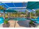 Relaxing pool area with patio furniture and lush landscaping at 1080 Bayshore Dr, Englewood, FL 34223