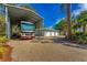 Covered RV parking with adjacent three-car garage at 1080 Bayshore Dr, Englewood, FL 34223