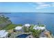 Stunning aerial view of waterfront homes, a pool, and a scenic bay at 11000 Placida Rd # 101, Placida, FL 33946