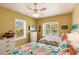 Bright bedroom featuring two floral-themed queen beds, a TV and a dresser at 1112 Andrews St, Englewood, FL 34224