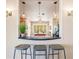 A view into the kitchen with a breakfast bar, granite countertops, and stainless steel appliances at 1112 Andrews St, Englewood, FL 34224