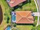 Overhead aerial perspective of the home with a screened pool, tile roof, and verdant landscaping at 13347 Golf Pointe Dr, Port Charlotte, FL 33953