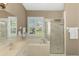 Well-lit bathroom with a soaking tub, separate shower with decorative glass, and a large window at 13347 Golf Pointe Dr, Port Charlotte, FL 33953