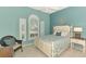 Well-lit bedroom with shuttered windows, comfortable bed, and a charming coastal decor scheme at 13347 Golf Pointe Dr, Port Charlotte, FL 33953