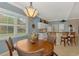 Charming dining area adjoining the kitchen, featuring a wooden table and views of the neighborhood at 13347 Golf Pointe Dr, Port Charlotte, FL 33953