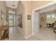 Inviting foyer with tile flooring, arched doorways, stylish artwork, and natural light from the front door at 13347 Golf Pointe Dr, Port Charlotte, FL 33953