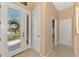 Bright foyer featuring tiled floors, double glass doors, and neutral-colored walls leading to various rooms at 13347 Golf Pointe Dr, Port Charlotte, FL 33953