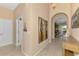 Spacious foyer with tiled flooring, artistic wall decor, and arched openings that provides open access to living areas at 13347 Golf Pointe Dr, Port Charlotte, FL 33953