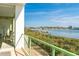 Private balcony overlooks the water with lush greenery and boat docks in view at 1375 Beach Rd # 109, Englewood, FL 34223