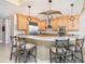 Updated kitchen featuring a stainless steel refrigerator, granite countertops, and pendant lighting at 1375 Beach Rd # 109, Englewood, FL 34223