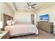 Cozy main bedroom with wood-look floors, a ceiling fan, and soothing neutral tones at 1375 Beach Rd # 109, Englewood, FL 34223