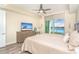 Comfortable main bedroom with wood-look floors, a ceiling fan, and water views at 1375 Beach Rd # 109, Englewood, FL 34223