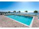 Inviting waterfront pool area with clear blue water and lounge chairs, perfect for relaxation with views of the bay at 1375 Beach Rd # 109, Englewood, FL 34223