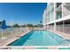 Relaxing waterfront pool offers cool swims with sunny skies and nearby lounge chairs at this beautiful condo complex at 1375 Beach Rd # 109, Englewood, FL 34223