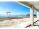 Expansive waterfront view with palm trees, a covered outdoor space, and views of the water at 1375 Beach Rd # 109, Englewood, FL 34223