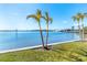 Picturesque waterfront view with lush greenery, palm trees, and a serene bay, perfect for relaxation and outdoor enjoyment at 1375 Beach Rd # 109, Englewood, FL 34223