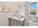 Bathroom featuring a large mirror, neutral vanity, and decorative accents at 13951 Allamanda Cir, Port Charlotte, FL 33981