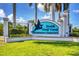 South Gulf Cove Waterfront Community sign with palm trees against a blue sky at 13951 Allamanda Cir, Port Charlotte, FL 33981