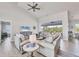 Comfortable living room with neutral furniture, ceiling fan, and a view of the screened-in lanai at 13951 Allamanda Cir, Port Charlotte, FL 33981