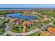 High aerial view of the home highlighting the beautiful lake, surrounding homes and lush landscaping at 14405 Silver Lakes Cir, Port Charlotte, FL 33953