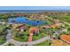 High aerial view of the home highlighting the beautiful lake, surrounding homes and lush landscaping at 14405 Silver Lakes Cir, Port Charlotte, FL 33953