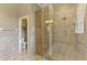 Bathroom features a glass-enclosed shower and access to a separate toilet room at 14405 Silver Lakes Cir, Port Charlotte, FL 33953