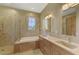 Elegant bathroom featuring double sinks, a soaking tub, and a separate shower at 14405 Silver Lakes Cir, Port Charlotte, FL 33953