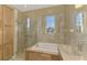 Bright bathroom offers a shower, soaking tub, and built-in storage cabinets at 14405 Silver Lakes Cir, Port Charlotte, FL 33953