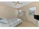 Cozy bedroom with a ceiling fan, dresser, and natural light from two windows at 14405 Silver Lakes Cir, Port Charlotte, FL 33953