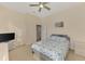 Bedroom showcasing a ceiling fan, dresser, and a comfortable bed at 14405 Silver Lakes Cir, Port Charlotte, FL 33953