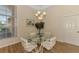 Dining room with glass table, striped chairs, modern chandelier and a large window at 14405 Silver Lakes Cir, Port Charlotte, FL 33953