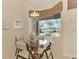 Cozy dining area featuring a glass table and views of the screened-in pool at 14405 Silver Lakes Cir, Port Charlotte, FL 33953