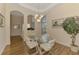 Dining room features modern glass table, striped chairs, and a view into other parts of the home at 14405 Silver Lakes Cir, Port Charlotte, FL 33953