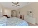 Bright main bedroom features a ceiling fan and a large dresser with a mirror at 14405 Silver Lakes Cir, Port Charlotte, FL 33953