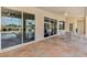 Covered patio features decorative stamped concrete, ceiling fan and a peaceful view of the pool and lake at 14405 Silver Lakes Cir, Port Charlotte, FL 33953